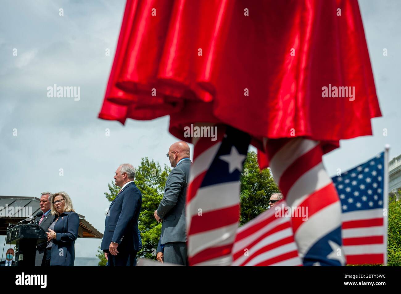 Michael Wheeler, of Kansas City, MO, wear his 'Super Jesus' outfit with cape and US flag, while House Minority Leader Rep. Kevin McCarthy (R-Calif.) holds a media availability with House Minority Whip Rep. Steve Scalise (R-LA), House GOP Conference Chairwoman Liz Cheney (R-WY) and others, to announce that Republican leaders have filed a lawsuit against House Speaker Nancy Pelosi and congressional officials in an effort to block the House of Representatives from using a proxy voting system to allow for remote voting during the coronavirus pandemic, outside of the U.S. Capitol in Washington, DC. Stock Photo