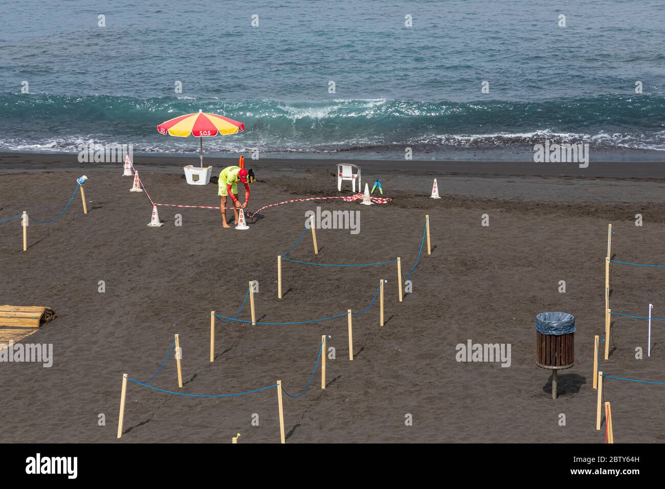 Playa de La Arena, Santiago del Teide, Tenerife, Canary Islands, Spain. 28th May, 2020. Workers prepare the beach with cordoned off areas to maintain social distancing, two metres apart, and controlled access for the public during Phase two of de-escalation of the Covid 19, coronavirus state of emergency which is expected to last until the 7 June. Stock Photo