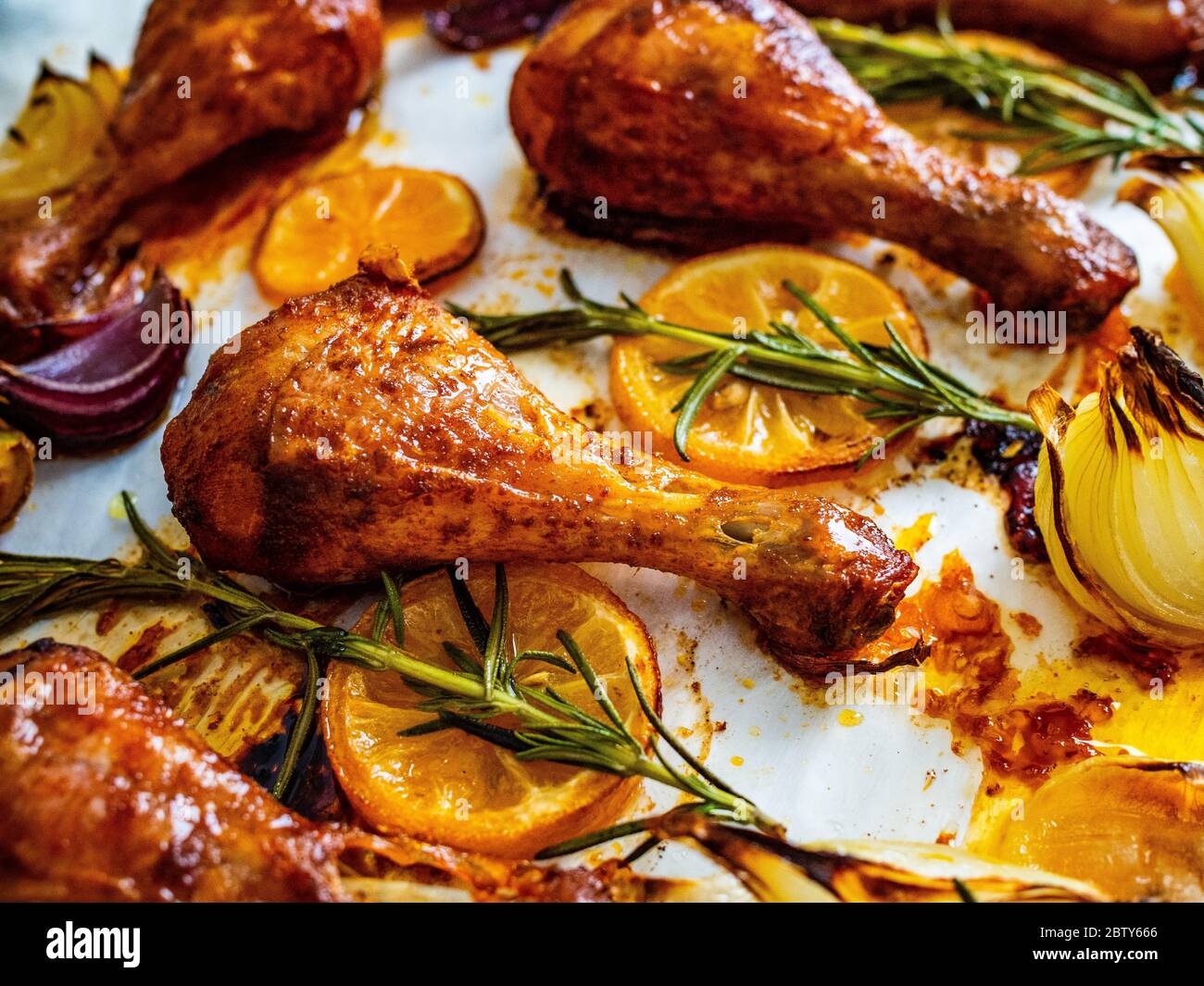 Grilled chicken drumsticks with onion and lemon Stock Photo
