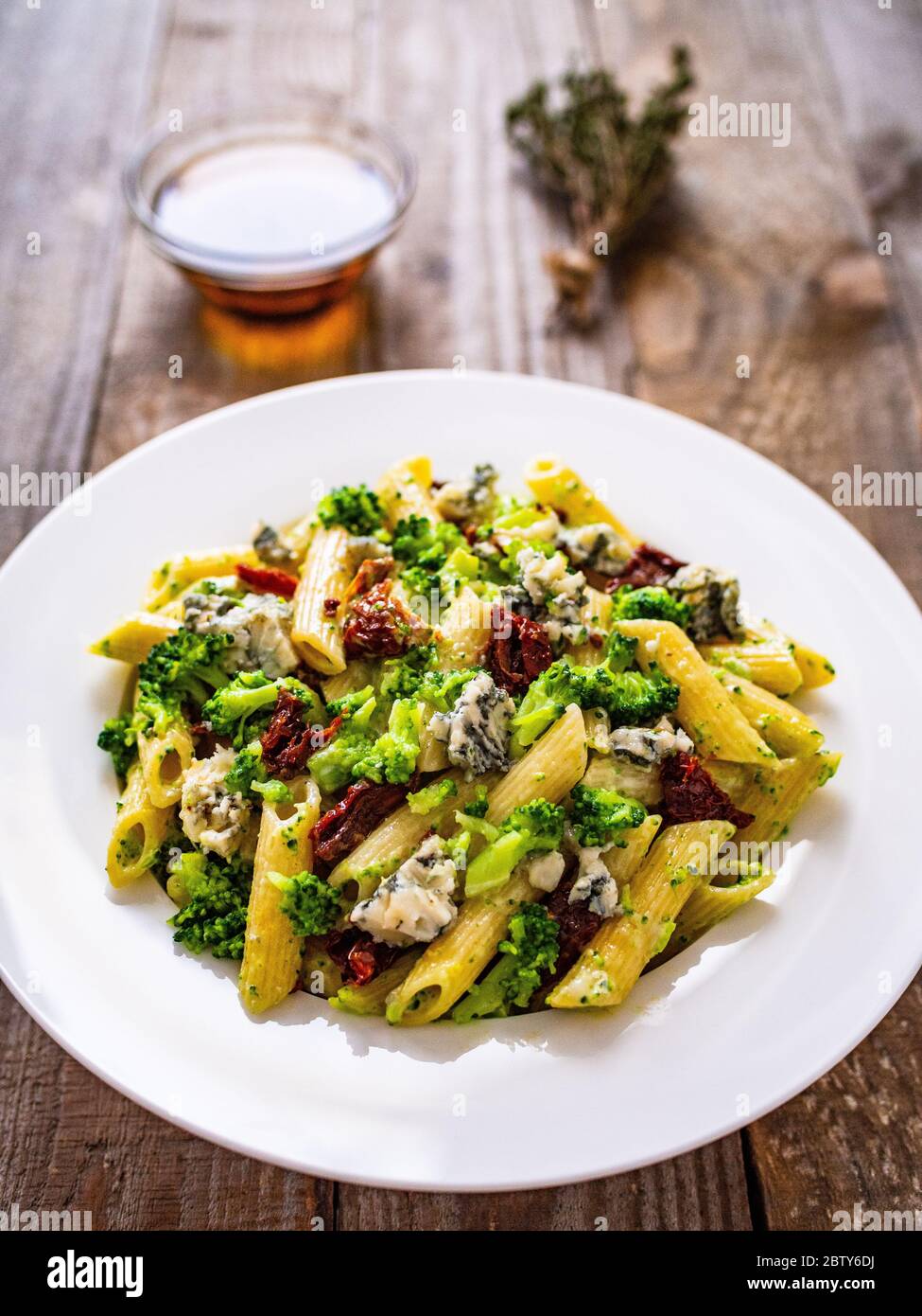 Penne with dried tomatoes and broccoli Stock Photo
