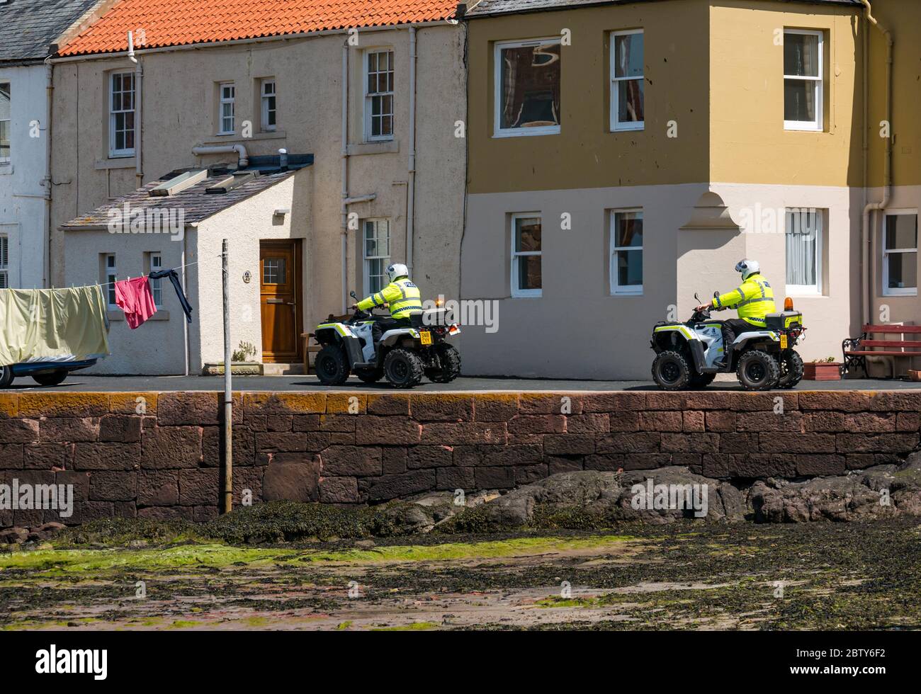 North Berwick, East Lothian, Scotland, United Kingdom, 28th May 2020. Easing of lockdown restrictions: with the Scottish Government set to announce the lifting of some lockdown restrictions today, there are already signs that things are beginning to return to normal in the popular seaside town. Police on quad bikes patrol the beach during the Covid-19 pandemic lockdown Stock Photo