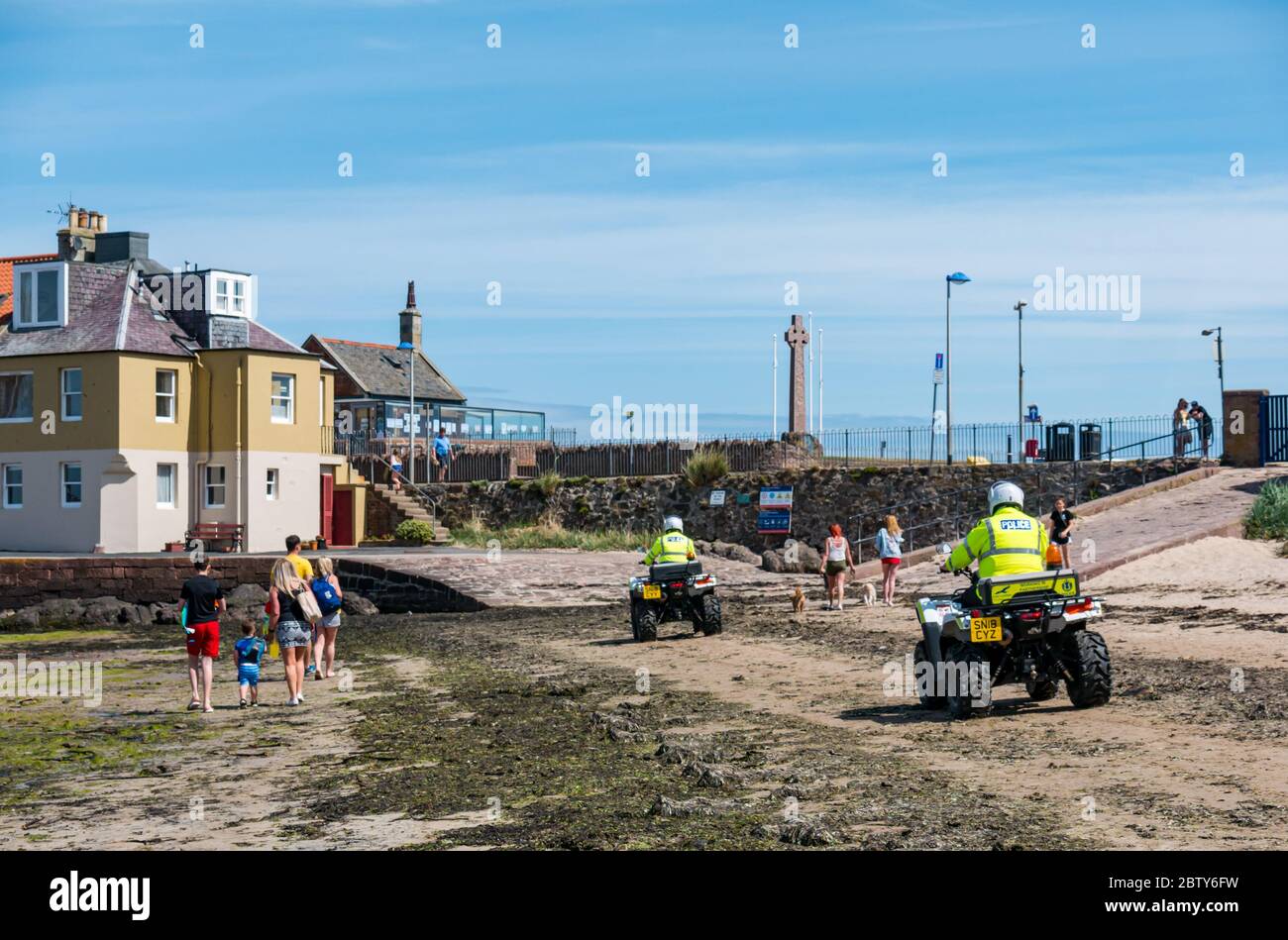 North Berwick, East Lothian, Scotland, United Kingdom, 28th May 2020. Easing of lockdown restrictions: with the Scottish Government set to announce the lifting of some lockdown restrictions today, there are already signs that things are beginning to return to normal in the popular seaside town. Police on quad bikes patrol the beach during the Covid-19 pandemic lockdown Stock Photo