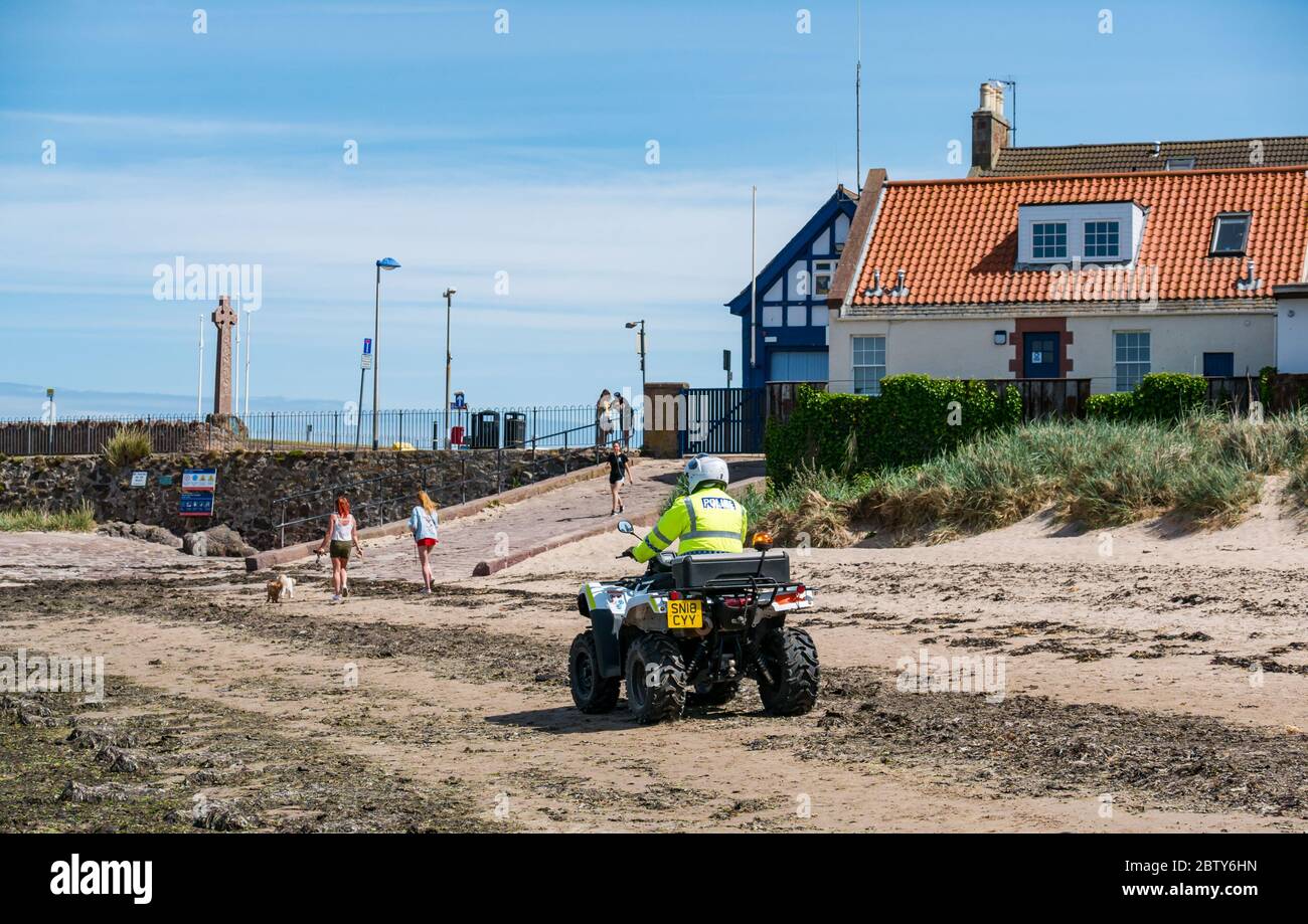 North Berwick, East Lothian, Scotland, United Kingdom, 28th May 2020. Easing of lockdown restrictions: with the Scottish Government set to announce the lifting of some lockdown restrictions today, there are already signs that things are beginning to return to normal in the popular seaside town. Police on a quad bike patrols the beach during the Covid-19 pandemic lockdown Stock Photo