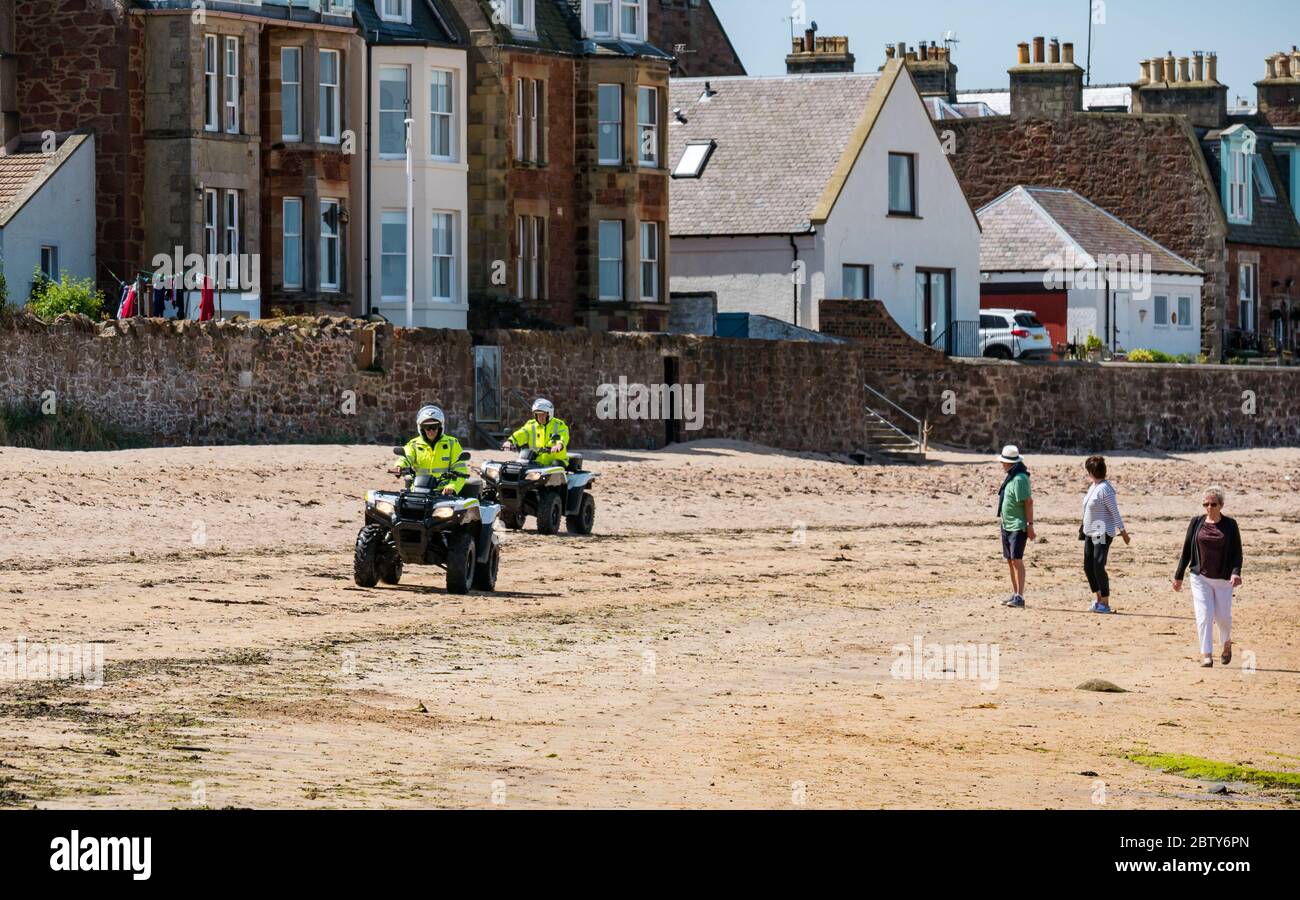 North Berwick, East Lothian, Scotland, United Kingdom, 28th May 2020. Easing of lockdown restrictions: with the Scottish Government set to announce the lifting of some lockdown restrictions today, there are already signs that things are beginning to return to normal in the popular seaside town. Police on quad bikes patrol the beach during the Covid-19 pandemic lockdown Stock Photo
