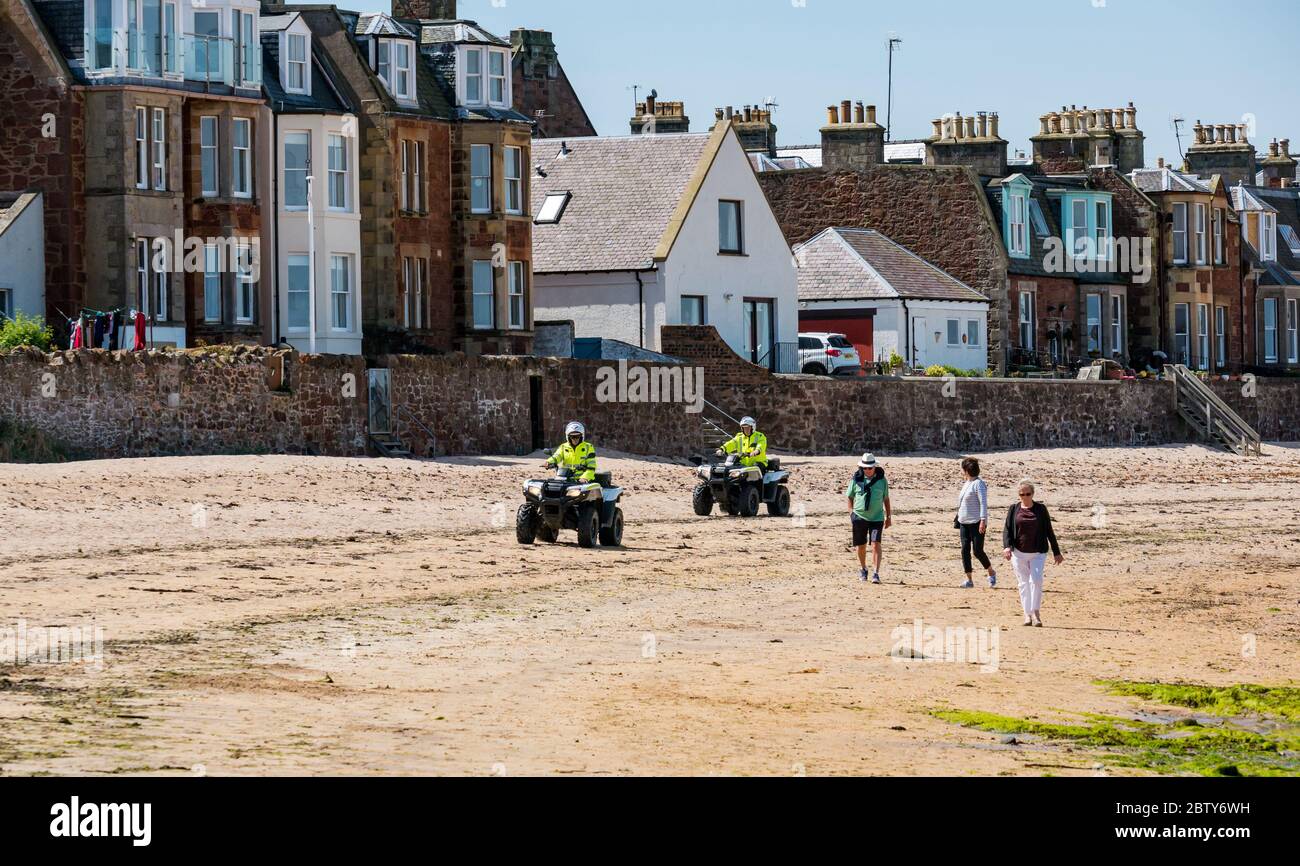 North Berwick, East Lothian, Scotland, United Kingdom, 28th May 2020. Easing of lockdown restrictions: with the Scottish Government set to announce the lifting of some lockdown restrictions today, there are already signs that things are beginning to return to normal in the popular seaside town. Police on quad bikes patrol the beach during the Covid-19 pandemic lockdown Stock Photo