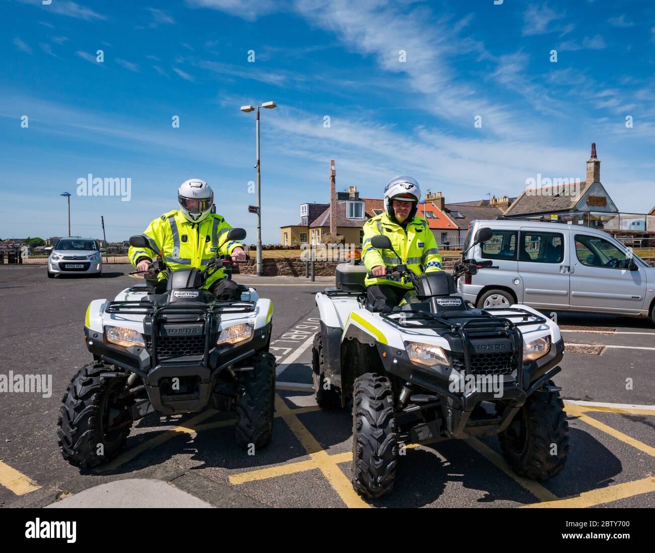 North Berwick, East Lothian, Scotland, United Kingdom, 28th May 2020. Easing of lockdown restrictions: with the Scottish Government set to announce the lifting of some lockdown restrictions today, there are already signs that things are beginning to return to normal in the popular seaside town. Police on quad bikes take a rest stop from their lockdown patrol Stock Photo