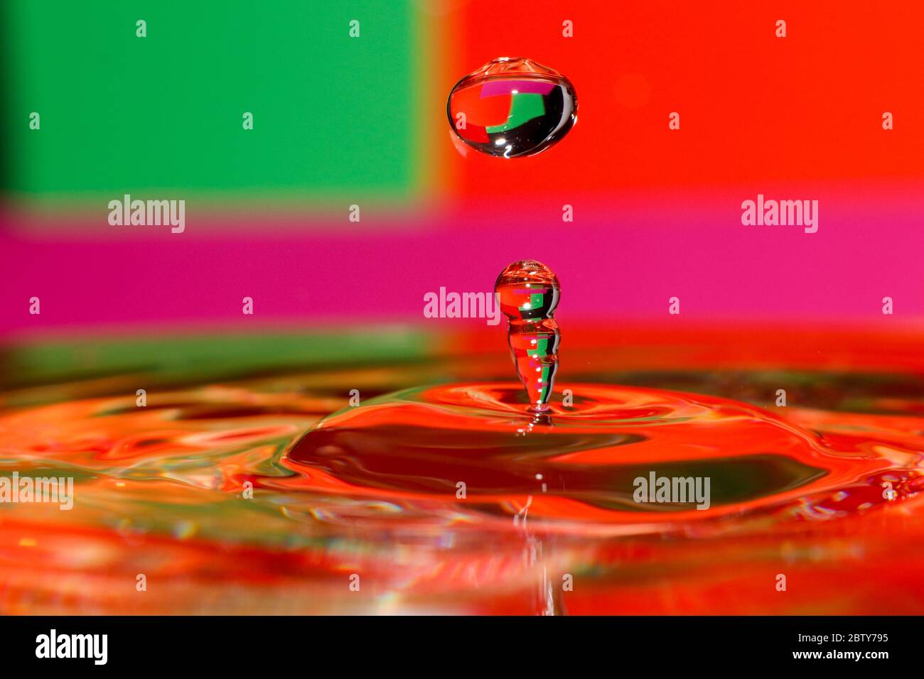 Drop of water with red green background Stock Photo
