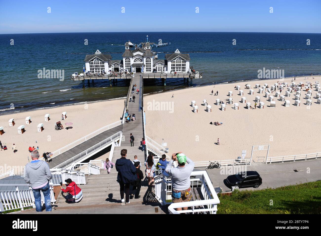 28 May 2020, Mecklenburg-Western Pomerania, Sellin: Tourists cross the pier in the Baltic resort Sellin. Day tourists, however, are not allowed to travel further into the federal state. Photo: Stefan Sauer/dpa-Zentralbild/ZB Stock Photo