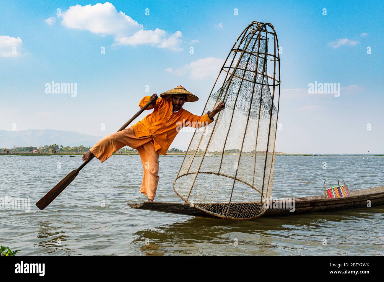 Fisherman at Inle Lake with traditional Intha conical net, fishing net