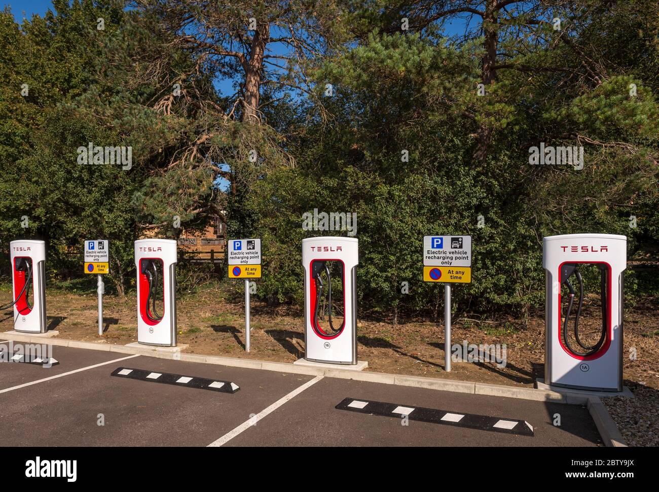 Electric vehicle charging points in a car park in England. Stock Photo