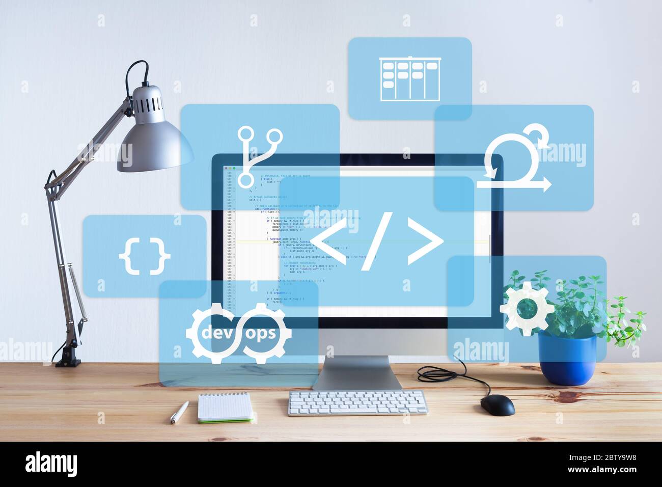 Software development workplace in bright office with wooden table, programming coding code on desktop computer screen, IT information technology devel Stock Photo