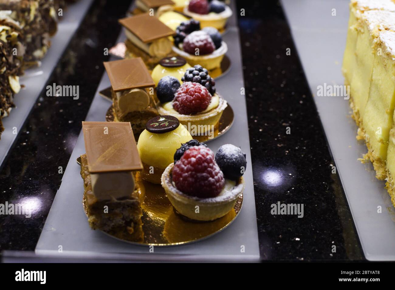 Various types of cakes, tart, mousse, pies for sale in bakery or pastry