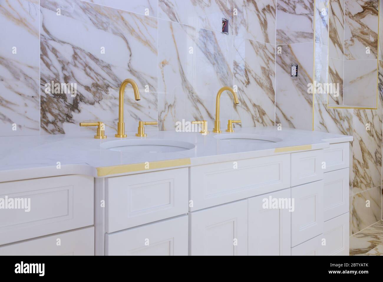 Luxury bathroom with marble white countertop faucet in washbasin