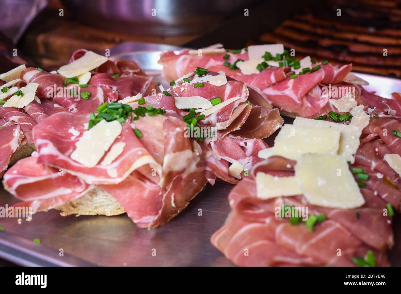Prosciutto, ham and cheese and bacon sandwiches canapes during hotel brunch buffet outside