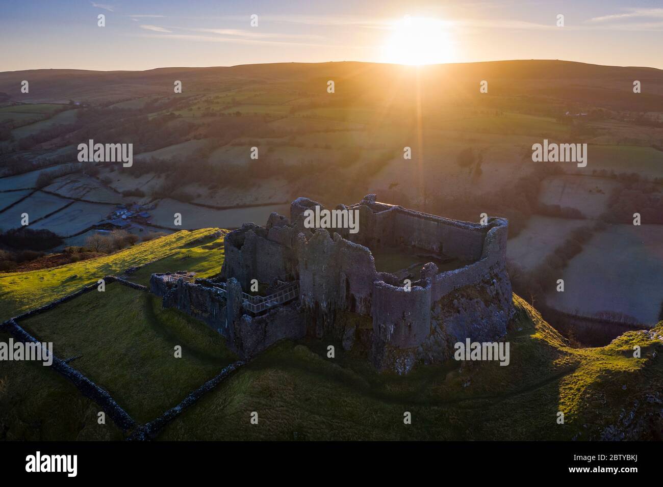 View by drone of sunrise over Carreg Cennen Castle in winter, Brecon Beacons National Park, Carmarthenshire, Wales, United Kingdom, Europe Stock Photo