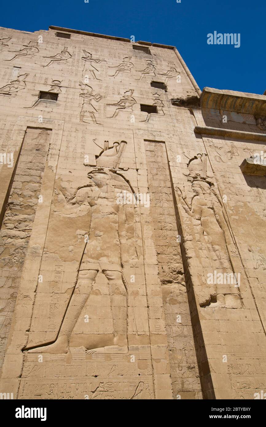 Bas Relief of God Horus on the left, First Pylon, Temple of Horus, Edfu, Egypt, North Africa, Africa Stock Photo