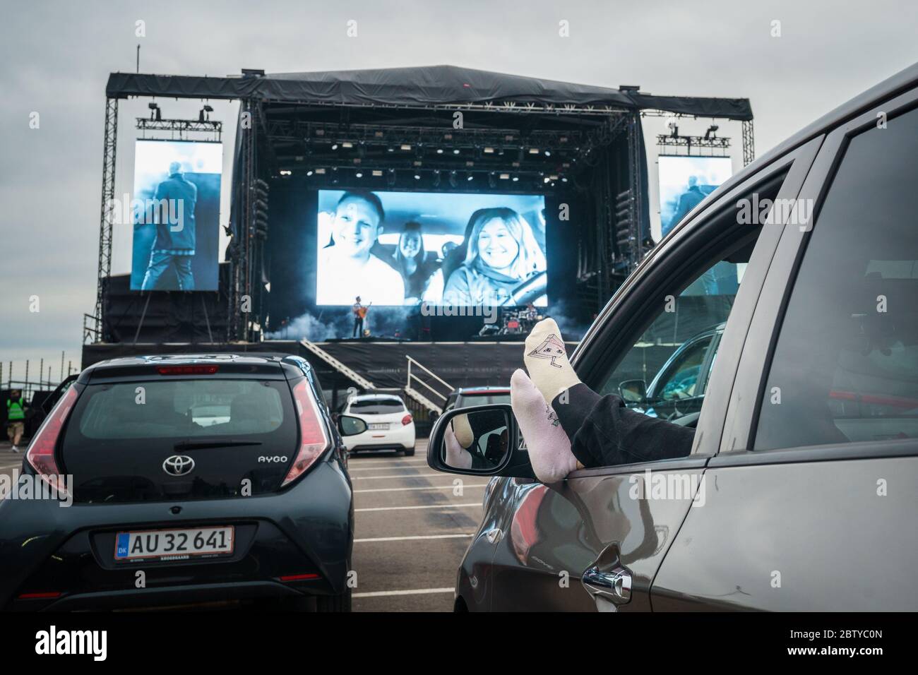 Copenhagen, Denmark. 27th May, 2020. The Danish rapper L.O.C. performs a live drive-in concert at the parking area outside Copenhagen Airport Kastrup. Due to the Corona virus and the lockdown of Denmark, the concert was organized as a drive-in concert where the audience watch the concert from their cars and with the audio streaming out of car radios. (Photo Credit: Gonzales Photo/Rod Clemen/Alamy Live News). Stock Photo