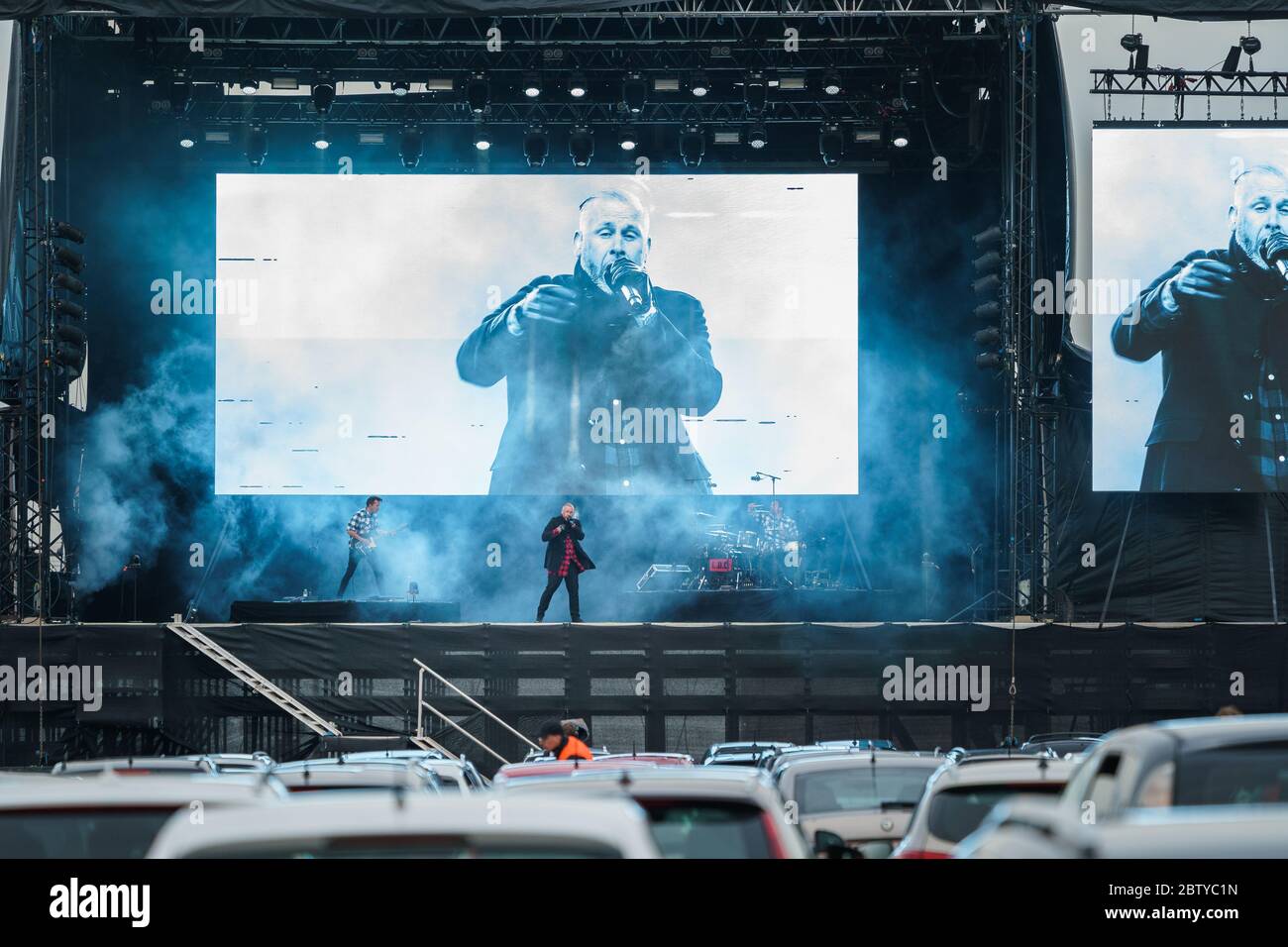 Copenhagen, Denmark. 27th May, 2020. The Danish rapper L.O.C. performs a live drive-in concert at the parking area outside Copenhagen Airport Kastrup. Due to the Corona virus and the lockdown of Denmark, the concert was organized as a drive-in concert where the audience watch the concert from their cars and with the audio streaming out of car radios. (Photo Credit: Gonzales Photo/Rod Clemen/Alamy Live News). Stock Photo