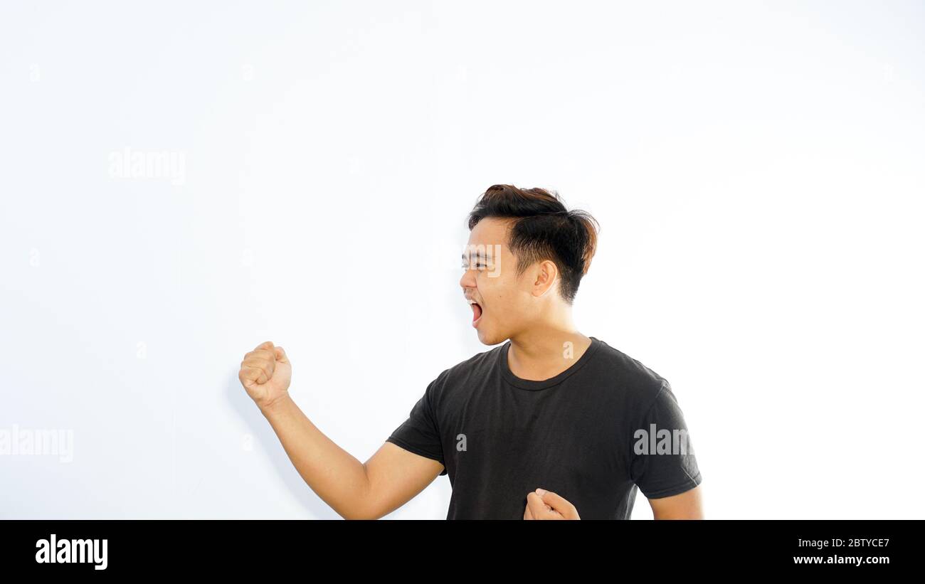Cheerful Young Attractive Asian Man Celebrating Success Stock Photo