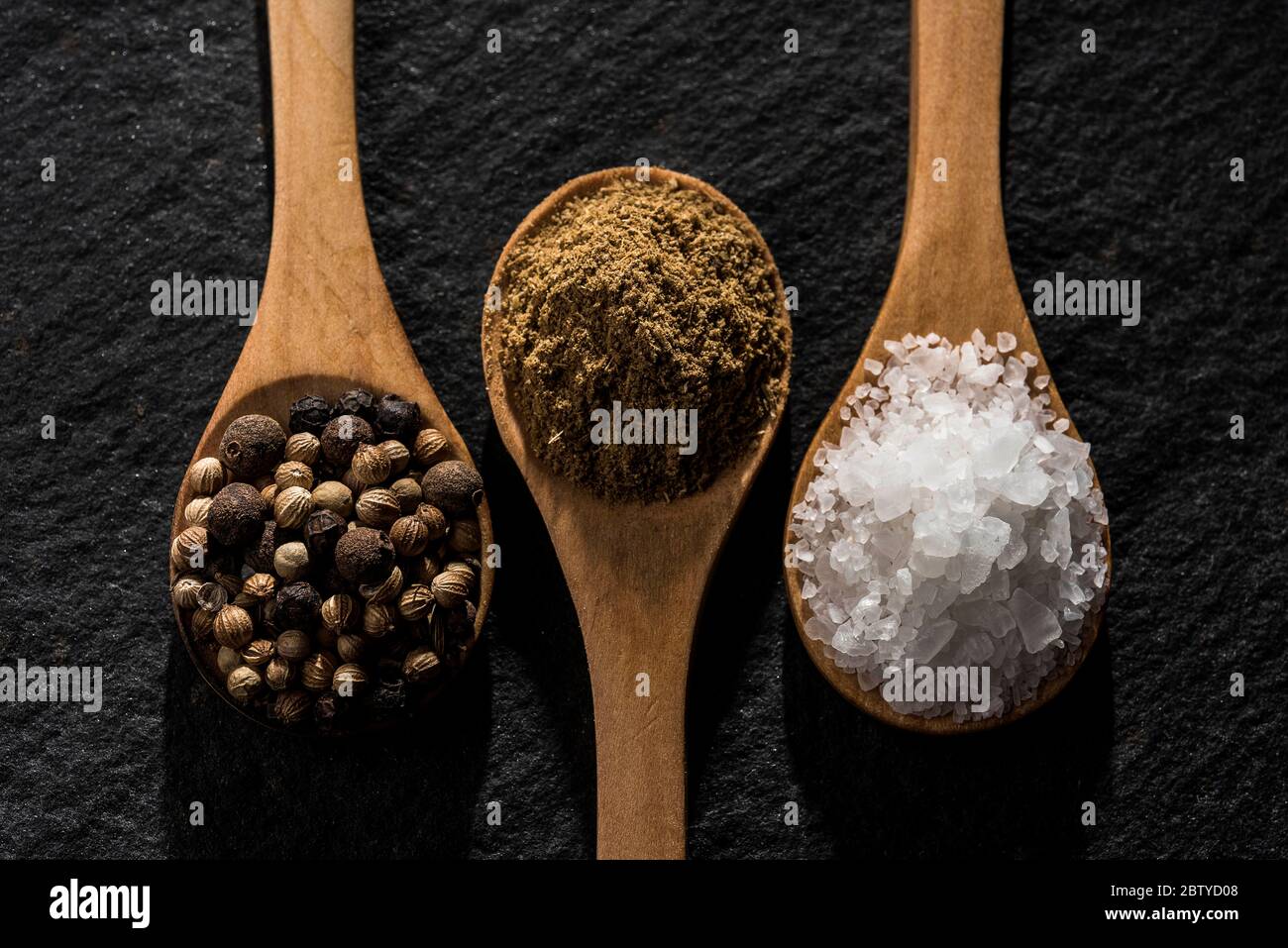 Wooden spoon with condiments Stock Photo Alamy