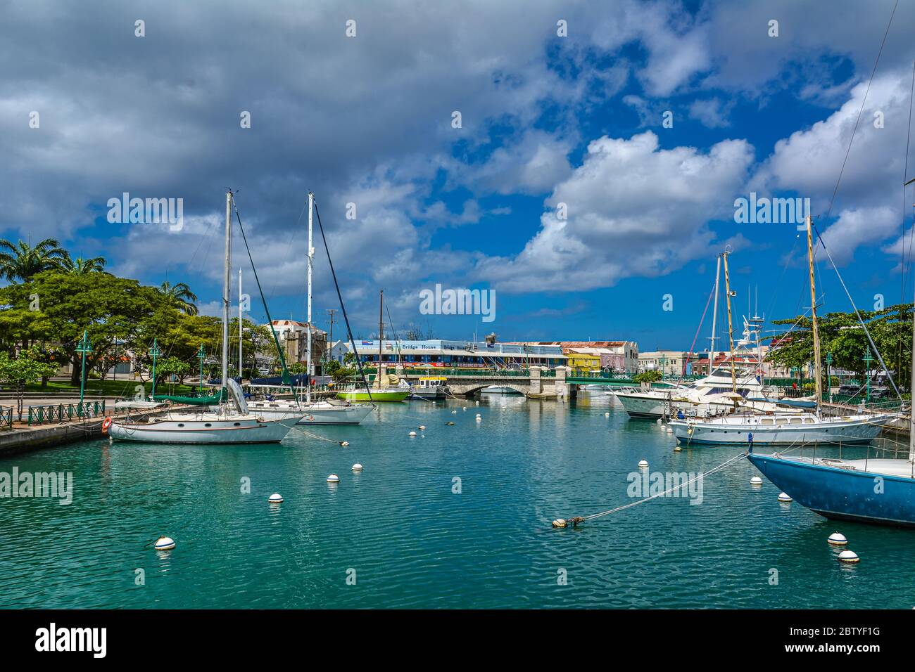 Bridgetown, Barbados, Caribbean - 22 Sept 2018: Sailing yachts moored in the downtown marina bay. White clouds in the blue sky. Copy space Stock Photo