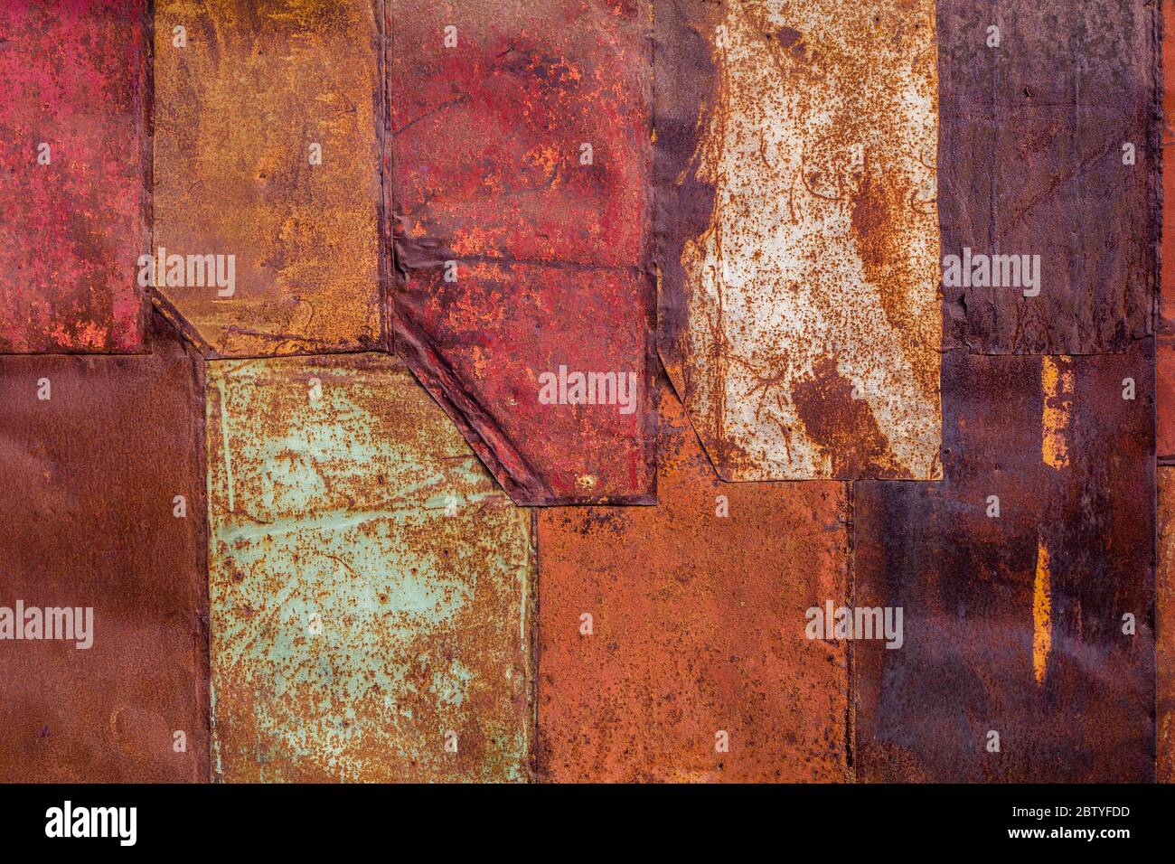 rusted tin sheets patchwork wall texture and flat background Stock Photo