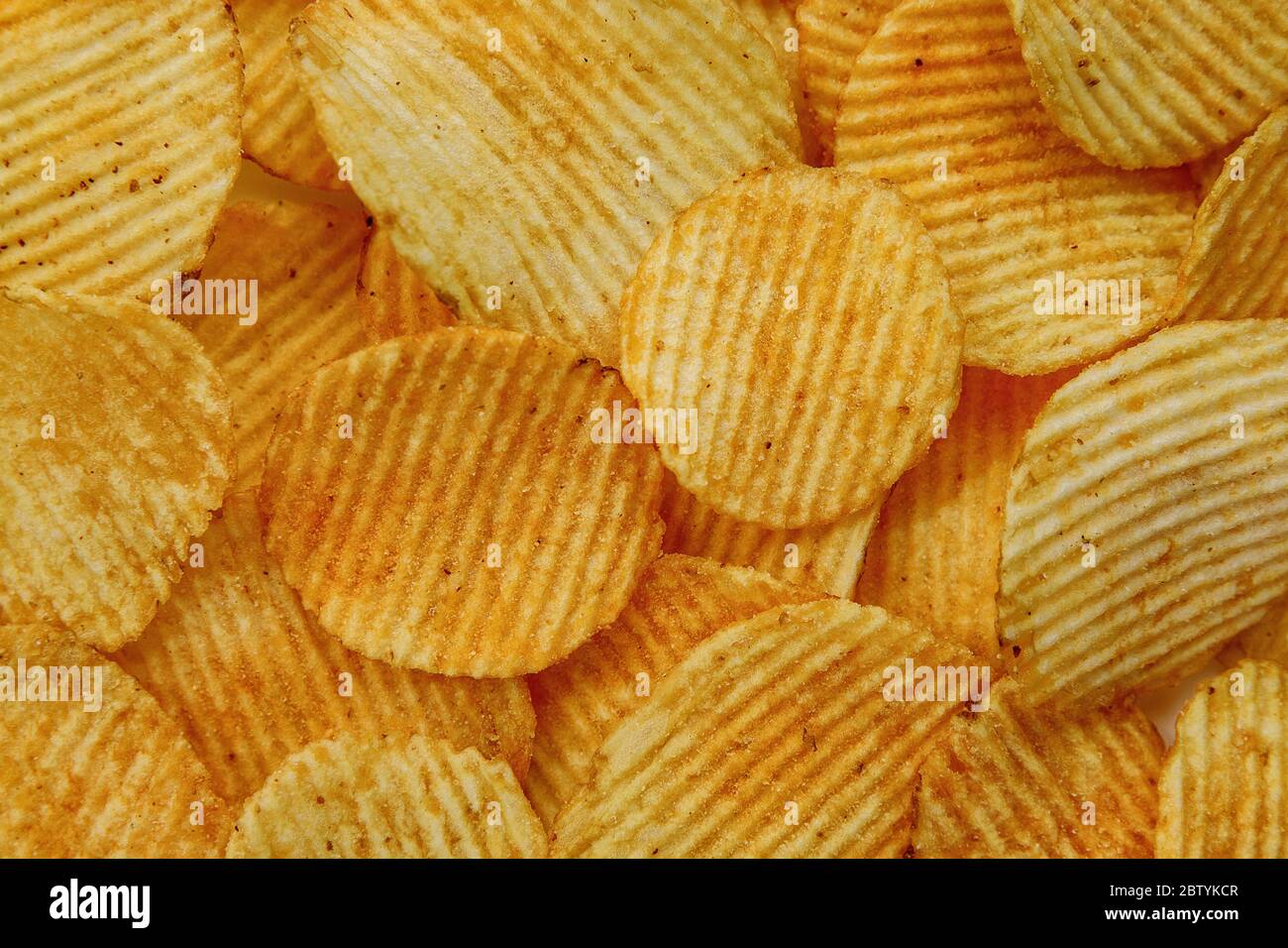 Corrugated Potato Chips. Food background. Top view. Stock Photo
