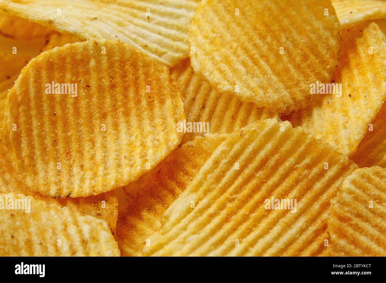Corrugated Potato Chips. Food background. Top view. Stock Photo