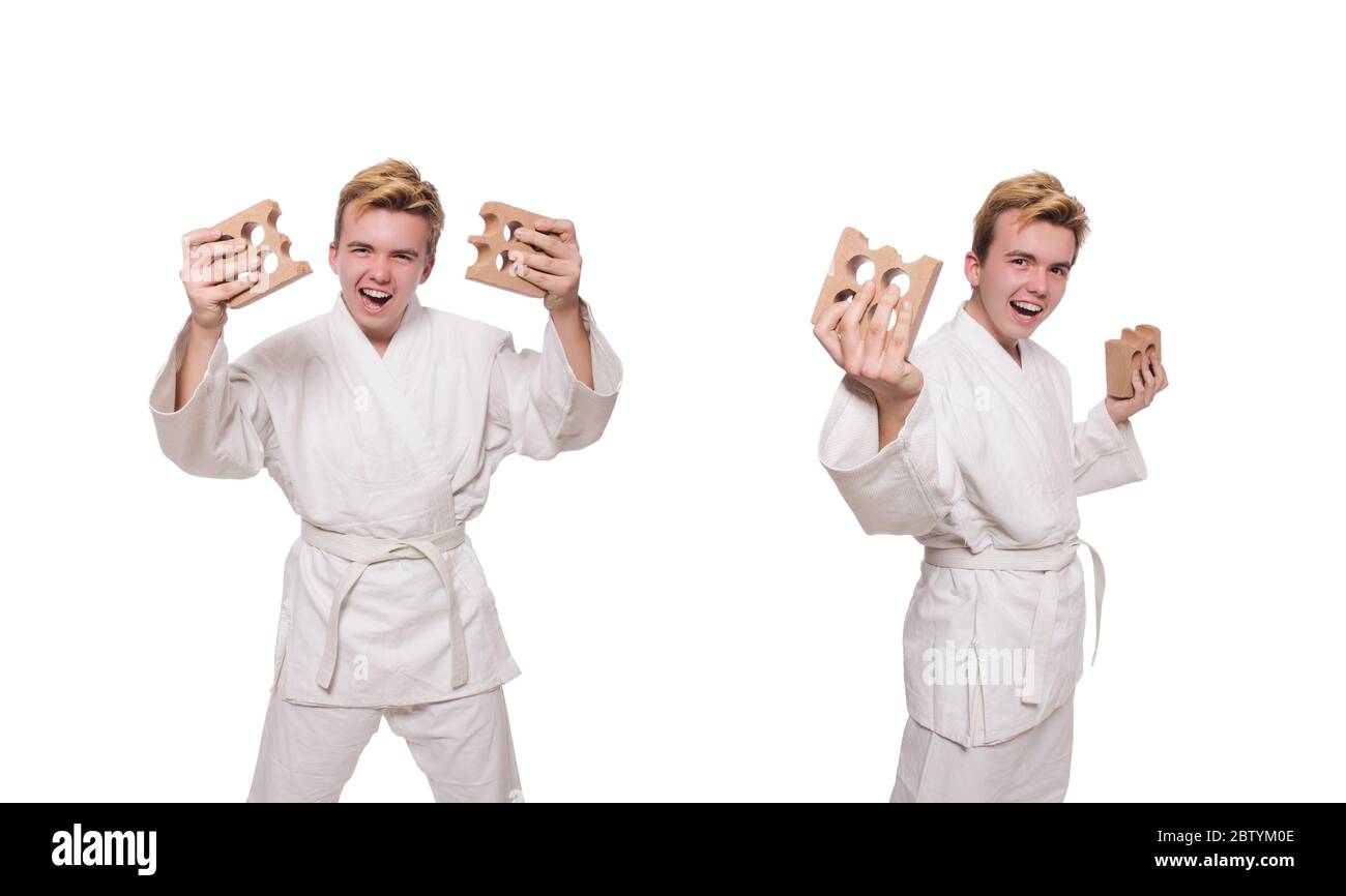 The funny karate man breaking bricks isolated on white Stock Photo