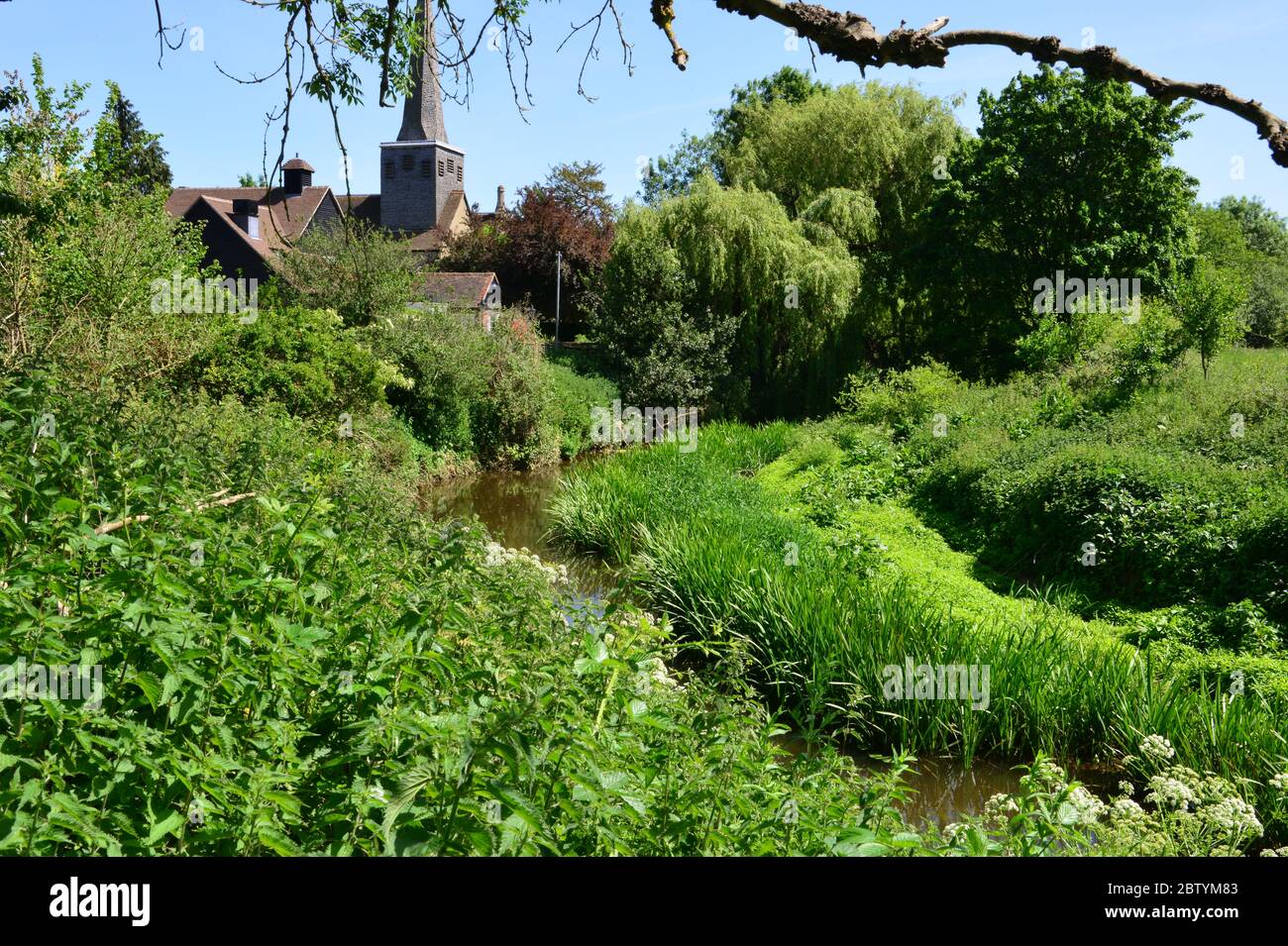 A church in the background of the winding River Mole in Horley, Surrey. Stock Photo