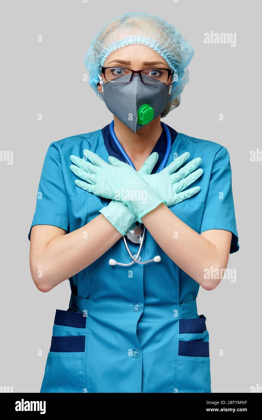 female doctor with stethoscope wearing protective mask and latex gloves ...