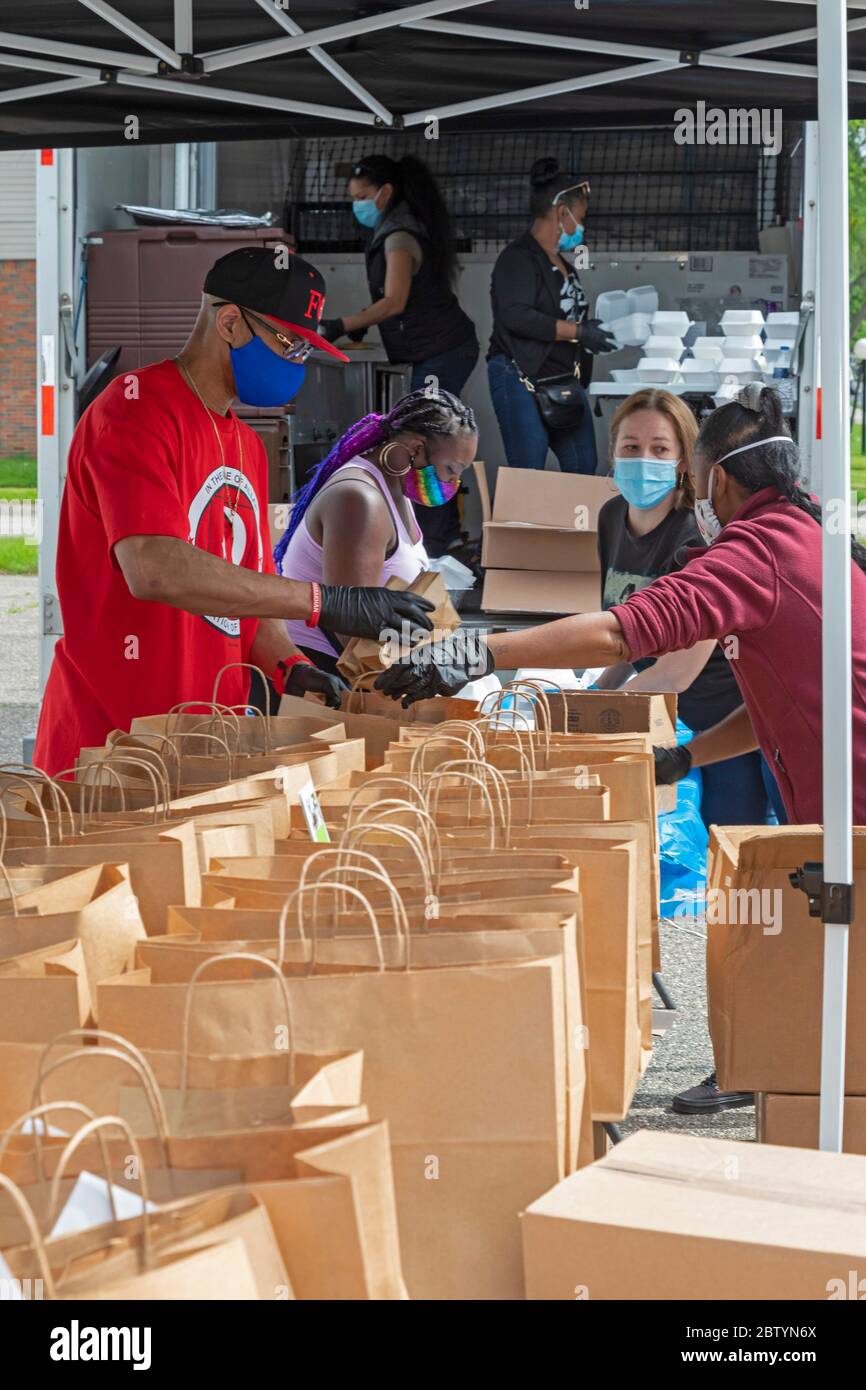 Detroit, Michigan - Volunteers package food for free distribution in a low-income neighborhood during the coronavirus pandemic. The distribution was o Stock Photo