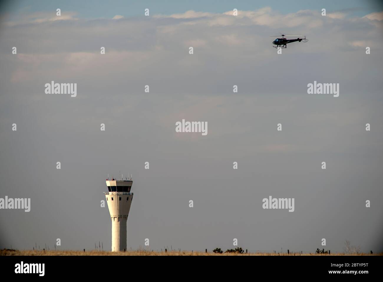 Helicopter Approaching to Land at Centennial Airport (KAPA) with the Air Control Tower in the Background Stock Photo
