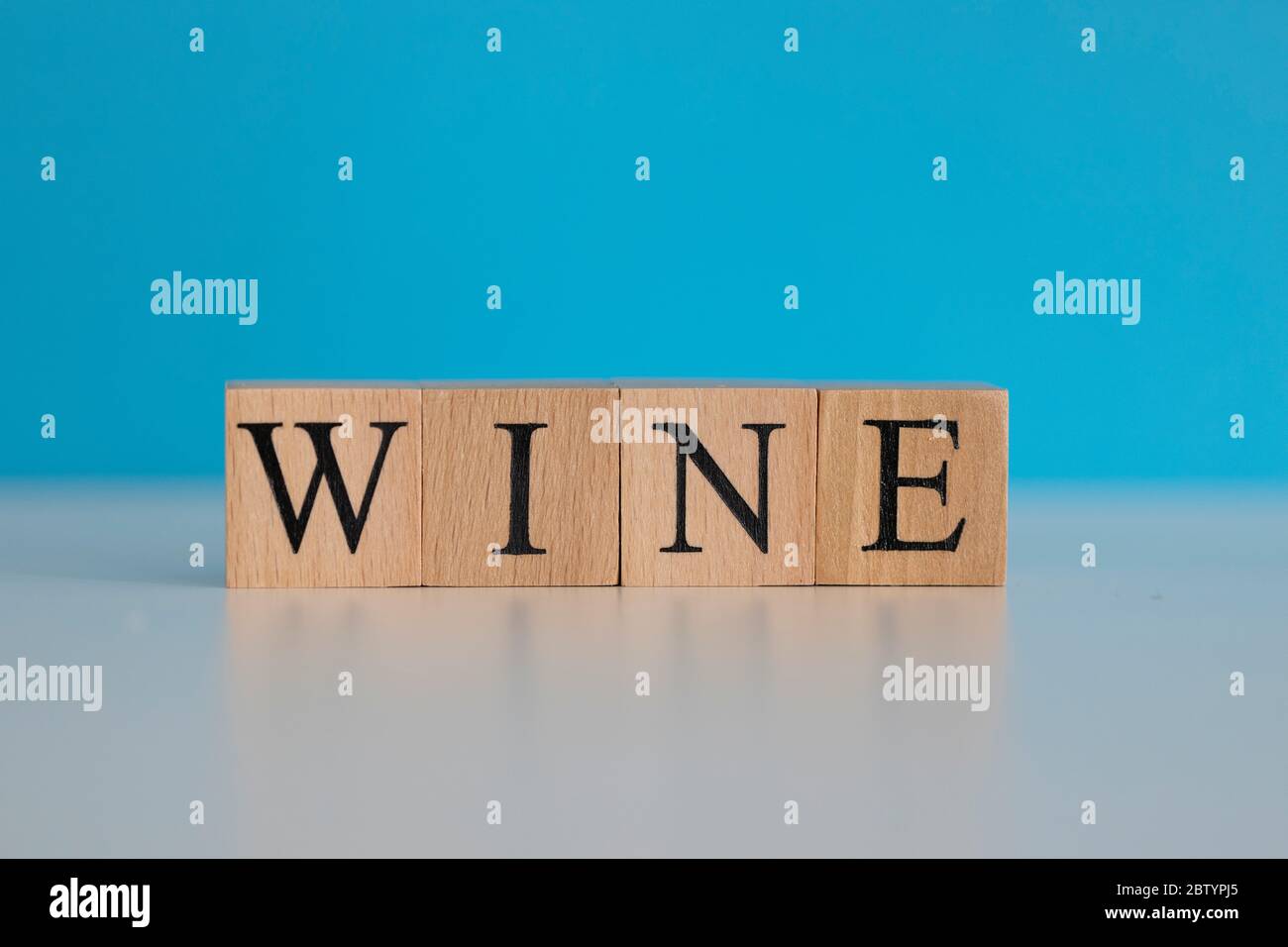 Wine word written on wood cube with blue background Stock Photo Alamy