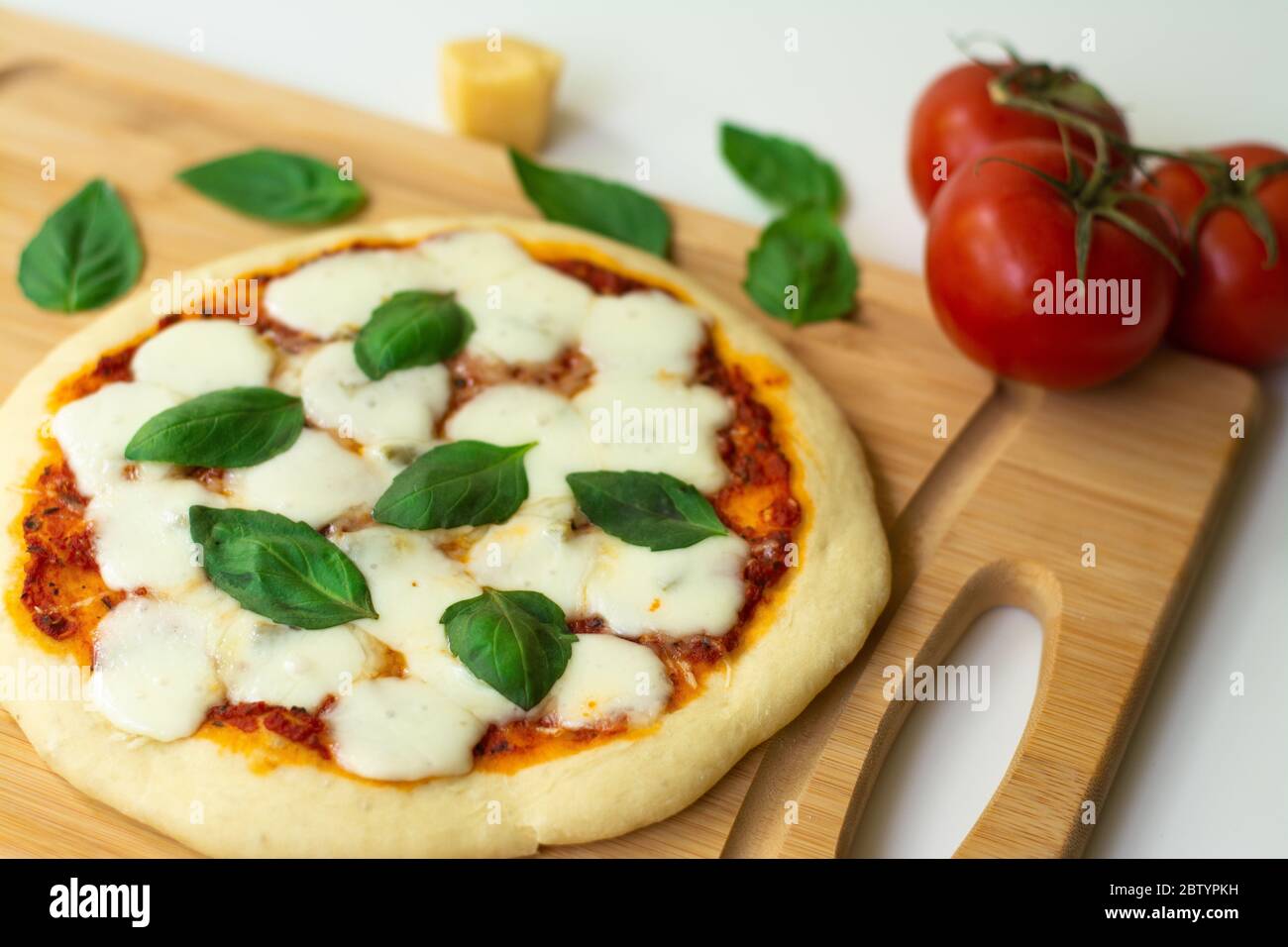 Homemade classic italian napoli pizza with tomato sauce, mozzarella cheese and basil leaves: pizza napoletana. Stock Photo