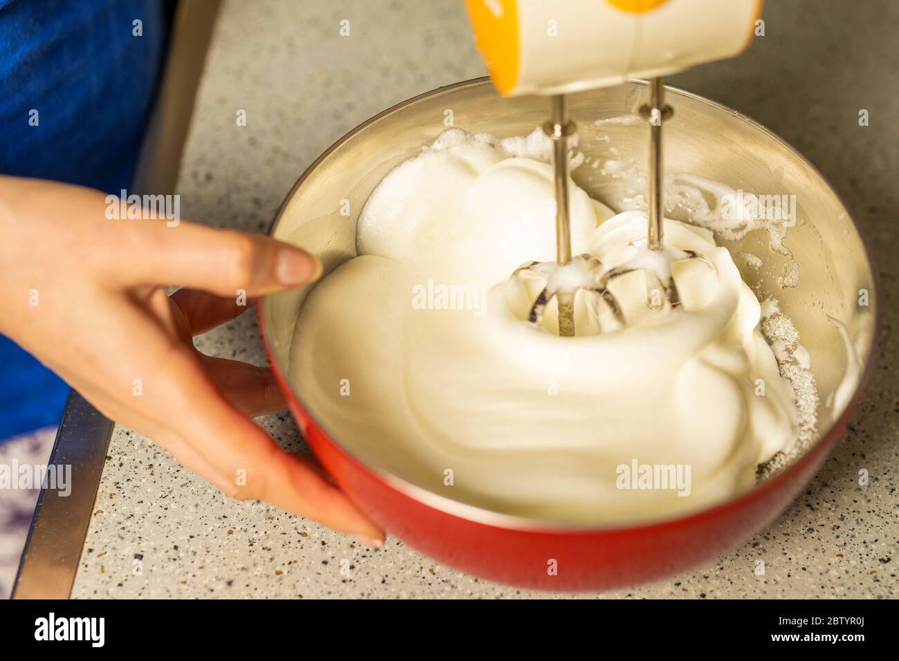 https://c8.alamy.com/comp/2BTYR0J/beating-a-white-cream-with-a-mixer-in-a-metal-bowl-whipped-cream-cream-for-the-cake-2BTYR0J.jpg