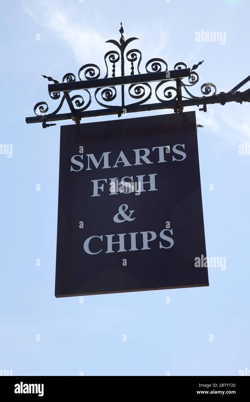 Smarts Fish and Chips sign hanging from a takeaway in the UK Stock Photo
