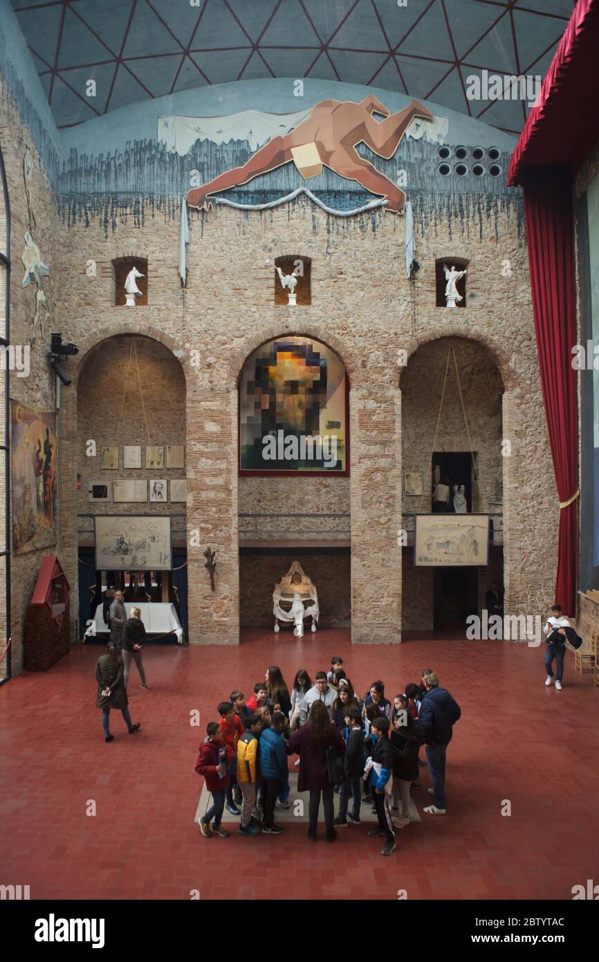 Group of visitors stays exactly on the unmarked grave of Spanish surrealist painter Salvador Dalí in the main hall of the Salvador Dalí Theatre and Museum in Figueres, Catalonia, Spain. The painting by Salvador Dalí entitled 'Lincoln in Dalivision' is seen in the background. Stock Photo