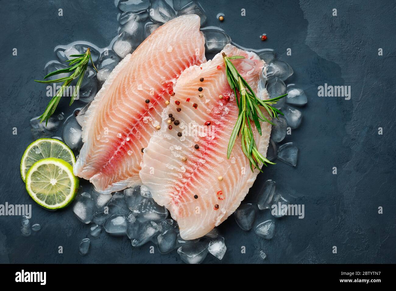 Glass baking tray with raw sea bass fish and ingredients in oven, closeup  Stock Photo - Alamy