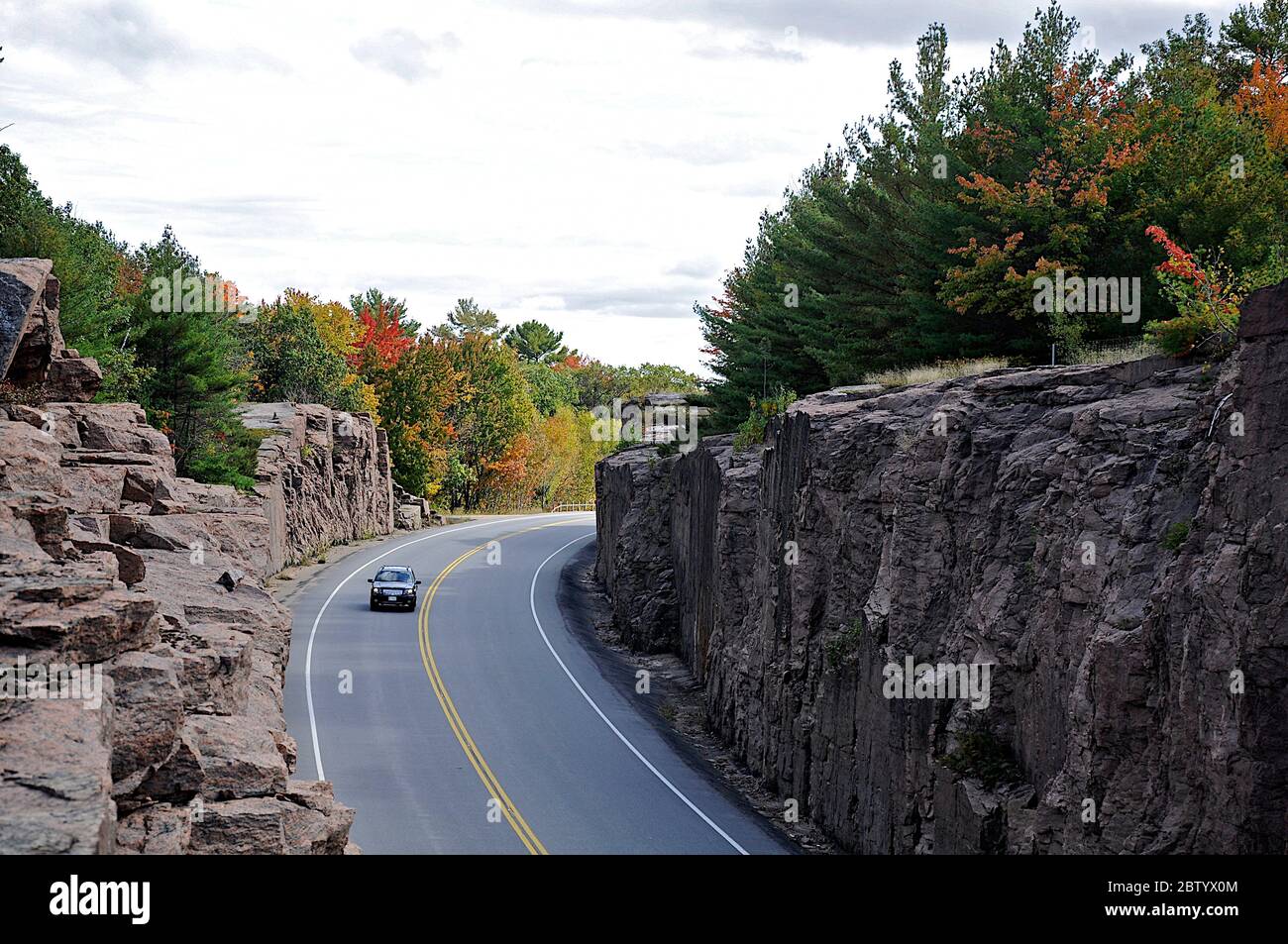 Milford Bay, Ontario / Canada - 10/05/2008: High angle view of Mountain road. Landscape with rocks, autumn leaves color, and beautiful asphalt road Stock Photo