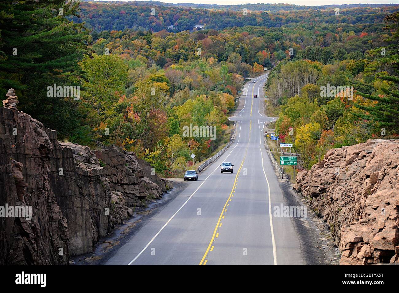 Milford Bay, Ontario / Canada - 10/05/2008: Mountain road. Landscape with rocks, autumn leaf color, and beautiful asphalt road in autumn. Stock Photo