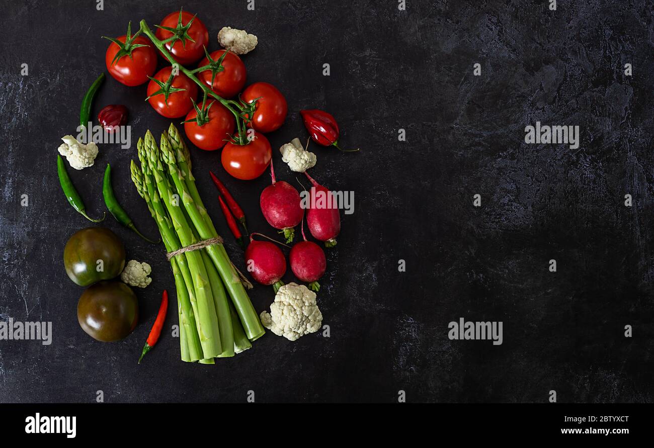 Fresh raw vegetables on black background view from above. Stock Photo