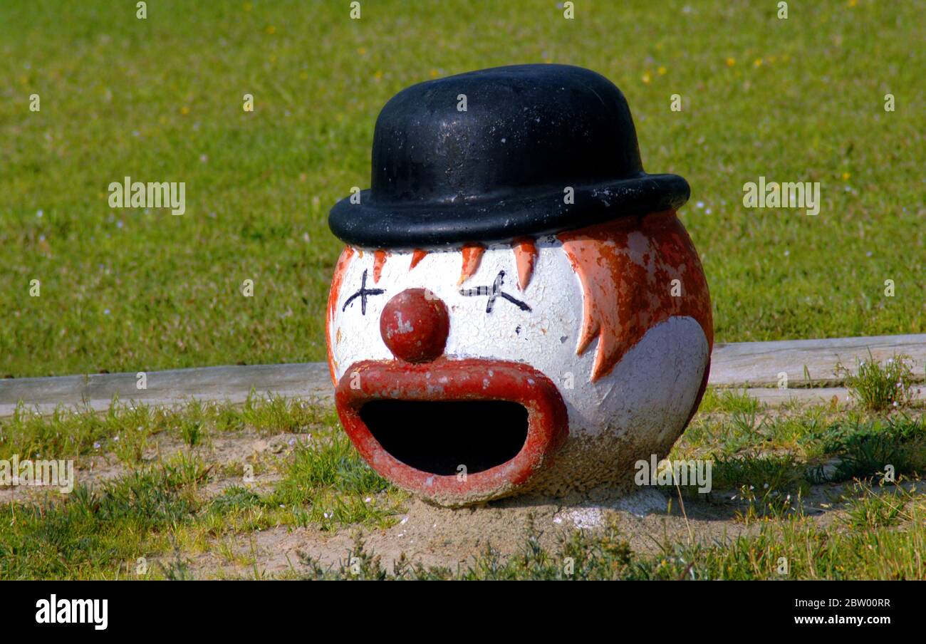 Head of clown statue shows mouth wide open as if he is telling jokes