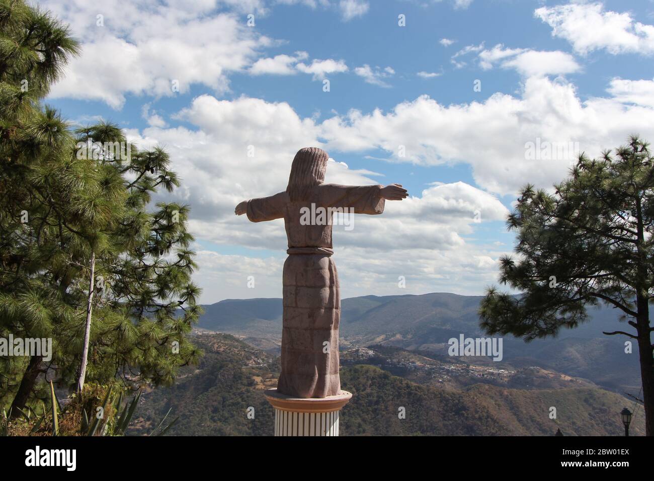 Christ Statue over the City of Taxco, Guerrero, Mexico with Blue Sky Stock Photo