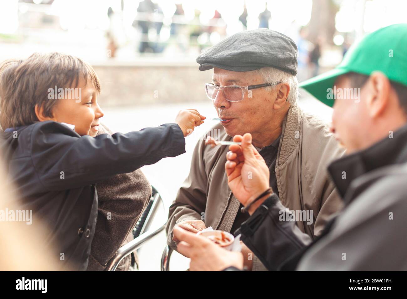 Grandson and granpa sharing ice cream Stock Photo