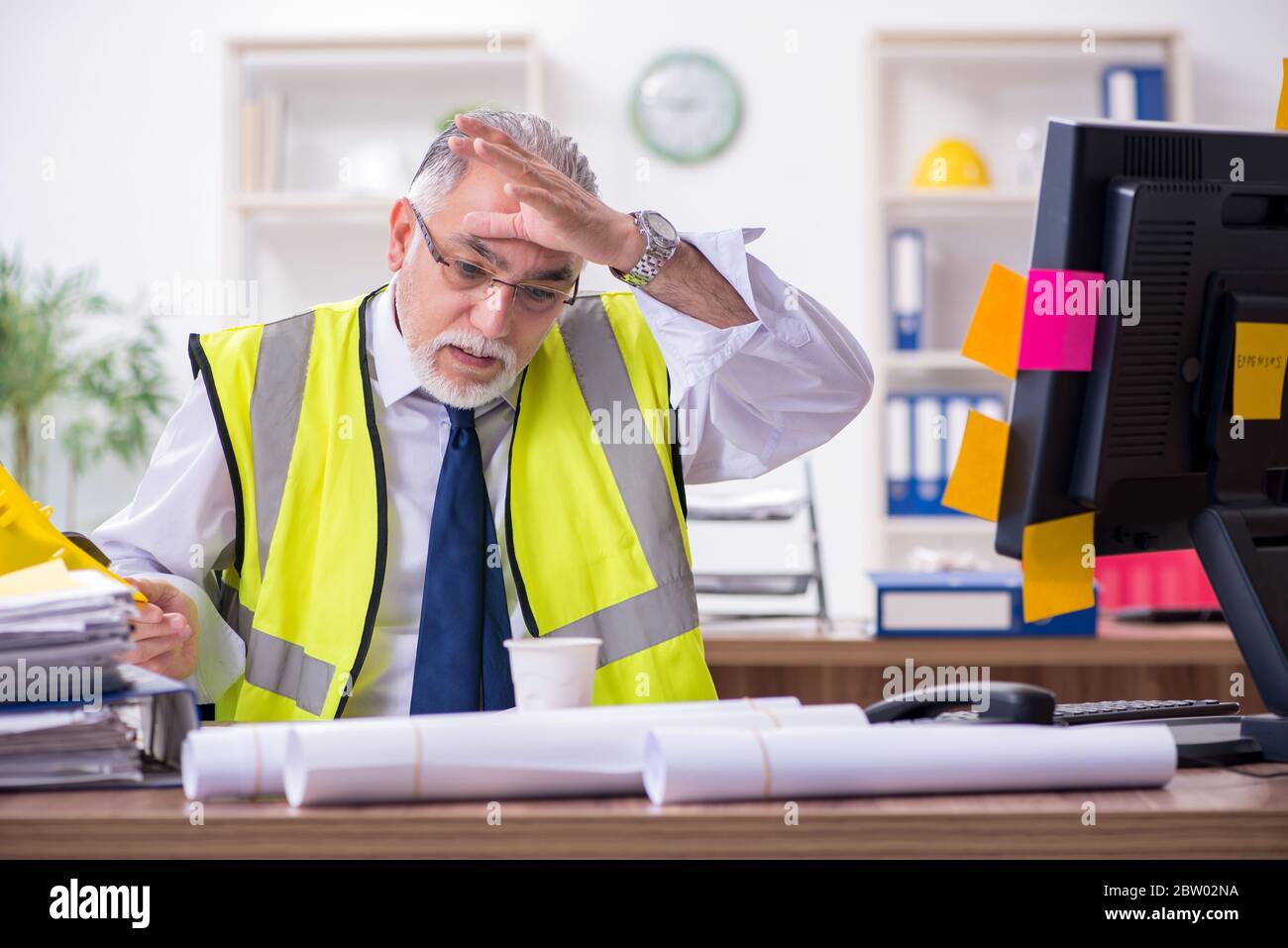 Old male architect working in office Stock Photo