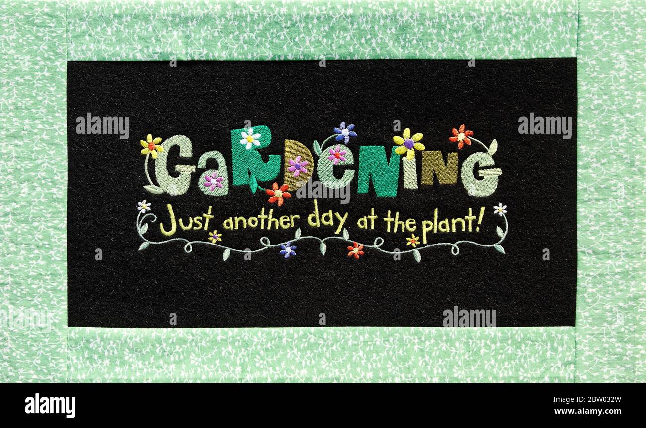 embroidered picture, words, text, Gardening Just Another Day at the Plant, stitchery, handcraft, colorful, black background, fabric, PR Stock Photo