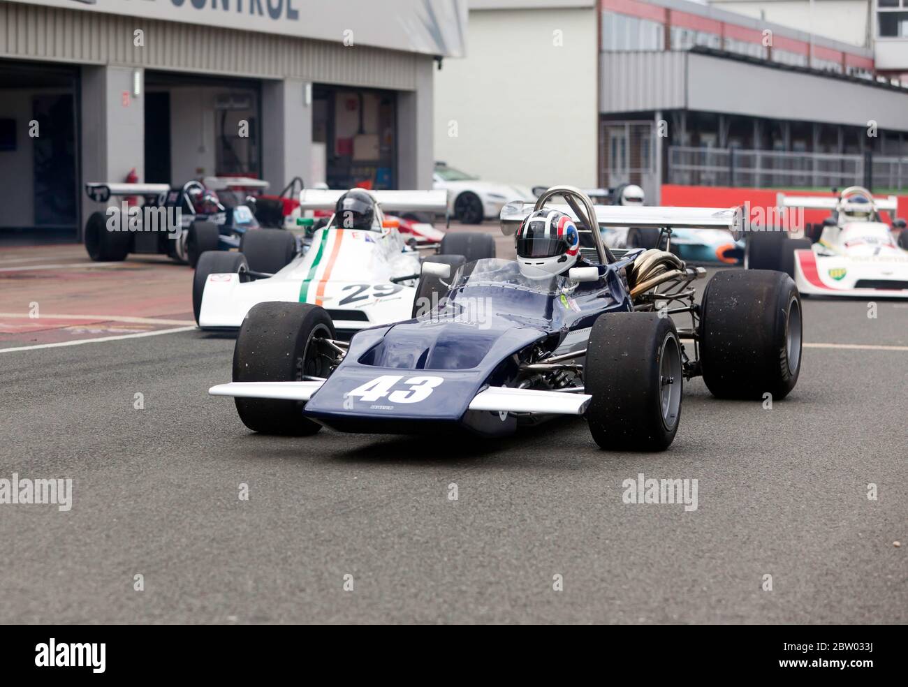 Niel Shinner in his March 712 leads out competitors for the qualifying session of the HSCC Historic Formula 2 Race at the 2019 Silverstone Classic Stock Photo