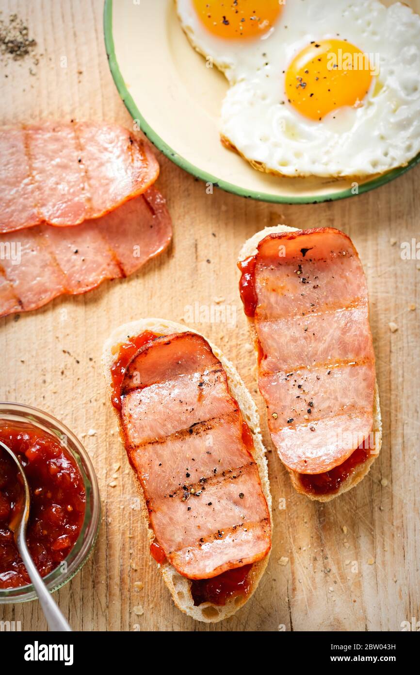 Bread with tomato relish and turkey rashers, fried eggs Stock Photo