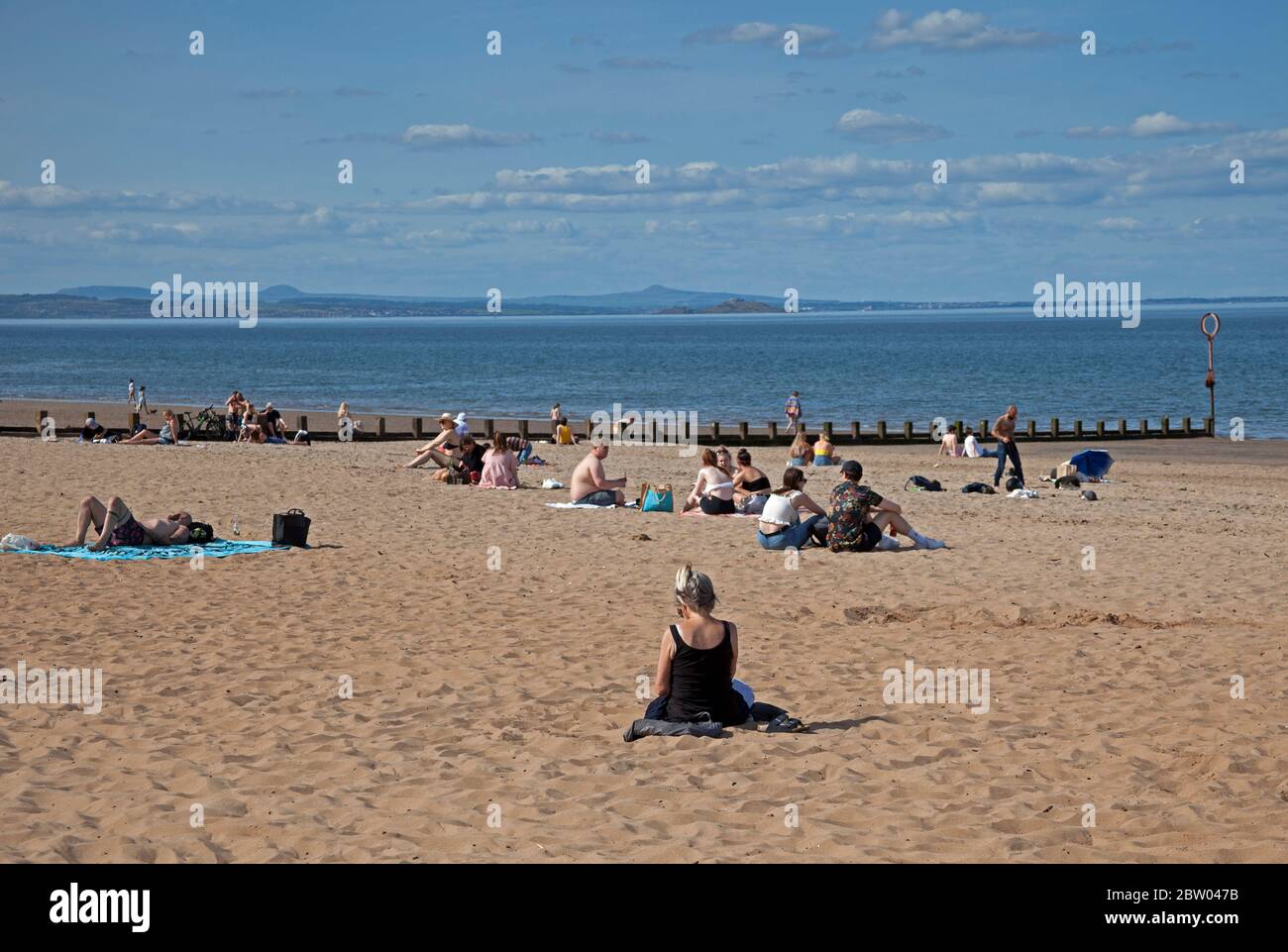 Portobello, Edinburgh, Scotland. 28 May 2020. 25 degrees late afternoon at the seaside. Reasonably busy beach and promenade with the Police in attendance continuing with the pass through but not bothering to talk to anyone regarding sitting around as the Scottish First Minister eases some of the restrictions for the Scottish public. Stock Photo